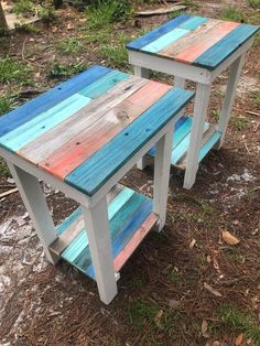 two wooden tables sitting on top of a grass covered field