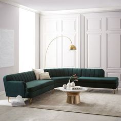 a living room with a green couch and white rugs on the floor next to a coffee table