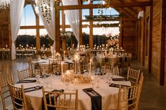 the tables are set up with candles and centerpieces for an elegant wedding reception