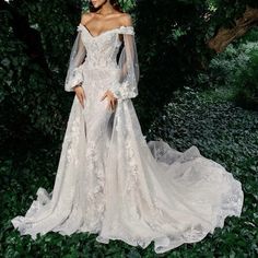 a woman in a white wedding dress is posing for the camera with her hands on her hips