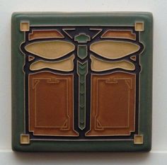 an art deco tile with dragonflys on it