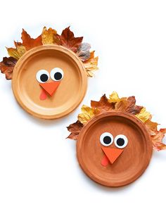 paper plate turkeys with leaves on them and eyes painted to look like they're ready for thanksgiving