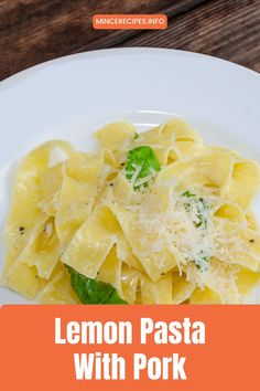 lemon pasta with pork and parmesan cheese on a white plate