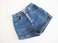 "Vintage 90s-2000s Anchor Blue denim shorts feature a high waisted fit, button fly, 5 pocket design, and sewn cuffs. Nice medium blue wash with great wear.  Brand: Anchor Blue Marked size:  5 Best fit: 24 waist Material: Cotton Excellent vintage condition Waist: 24\" Hips: 36\" Length: 12.5\" Rise: 12\"" Cheap Blue 90s Jean Shorts, Cheap 90s Short Jeans, 90s Fitted Bottoms With Button Closure, High Waist Denim Shorts With Buttons, Medium Wash High-waisted Shorts With Button Closure, Medium Wash High-waisted Jean Shorts With Button Closure, High-waisted Medium Wash Jean Shorts With Buttons, High Waist Medium Wash Jean Shorts With Buttons, Vintage Shorts With Button Closure