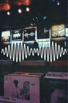 an image of sound waves on display in a music store with record players and records