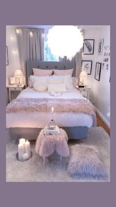 a bedroom decorated in white and pink with fur rugs on the floor, candles lit up