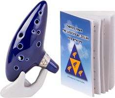 a blue and white book holder next to a book with an image of a musical instrument on it