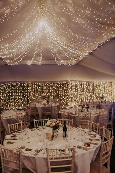 the tables are set with white linens and place settings for an elegant wedding reception