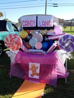 a candy land stand with lollipops, candies and other sweets on it