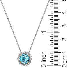 Sterling Silver Swiss Blue Topaz and Created White Sapphire Necklace  Adorn your neckline with the luxe look of this genuine gemstone necklace. Strung on a diamond-cut, cable chain, this classic drop design features a beautiful blue topaz surrounded with a sparkling halo of created white sapphires.        Necklace approx. 18"L      Drop approx. 11.9mm x 11.9mm     Stamped .925; rhodium plating; 18K yellow gold accents on prongs     Two-tone polished finish     Diamond-cut cable chain; lobster claw clasp   Stone Information       All sizes and weights approximate     Swiss Blue Topaz - Faceted round; 2.13ct     Created White Sapphire - Faceted round; 16pc; 0.15ctw White Sapphire Necklace, Silver Drop Necklace, Drop Design, Round Necklace, Cz Necklace, Sapphire Pendant, Swiss Blue Topaz, Sapphire Necklace, Amethyst Necklace