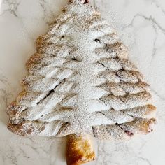 a pastry shaped like a christmas tree with powdered sugar on top