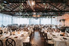 an indoor dining area with tables and chairs set up for formal function or wedding reception