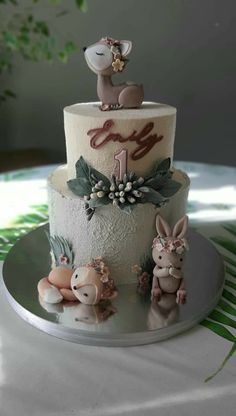 a three tiered cake with figurines on top