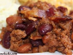 a white plate topped with meat and beans