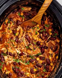 a slow cooker filled with beans and chicken