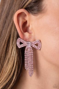 Featuring silver square fittings, high-sheen bands of silver, adorned in sparkling pink rhinestones loop into a stunning bow charm, creating a classy statement at the ear. Featured in the center of the classy design, a trio of emerald-cut pink gems tie the bow together emitting further sheen and glitz. Earring attaches to a standard post fitting. Sold as one pair of post earrings. Classy Design, Pink Gem, Vip Group, Butterfly Jewelry, Paparazzi Accessories, White Rhinestone, Paparazzi Jewelry, Pink Earrings, Girly Jewelry