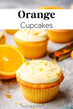 orange cupcakes with white frosting and an orange slice