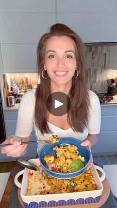 a woman is holding a bowl with food in it