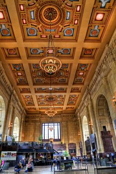 an ornate ceiling with chandeliers and paintings on the walls in a large building