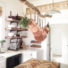 pots and pans hanging from the ceiling in a kitchen