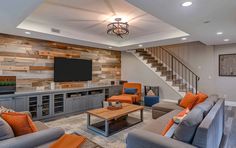 a living room filled with furniture and a flat screen tv mounted on a wall above a fire place