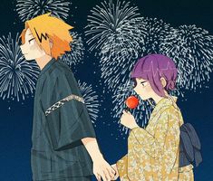 two people standing next to each other with fireworks in the sky behind them and one person holding an apple