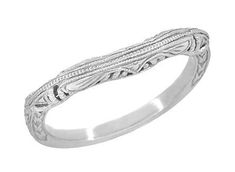 a white gold wedding band with intricate design