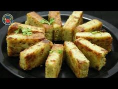 a black plate topped with slices of bread and garnished with parsley on top