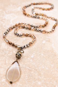 Indulge in the beauty of our Debbie Necklace Brown/Dalmation. This beaded strand necklace boasts shimmering crystal and stone beads, elegantly knotted between each one. The stunning pendant, featuring a polished stone, adds a unique and sophisticated touch. Elevate any outfit with this luxurious accessory! Stone Bead Necklace, قلادات متدلية, Semi Precious Necklace, Pink Pineapple, Beaded Jewelry Necklaces, Diy Jewelry Necklace, Beaded Necklace Diy, Stone Beaded Necklace, Jewelry Lookbook