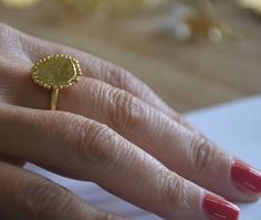 Gold disc ring, gold round ring, gold statement ring, gold cocktail ring, round disc ring, organic design ring, disc ring, matte gold ring Handmade hammered gold disc, decorated with tiny gold bits of metal (granulates) and soldered to a gold plated band. The ring was made in an organic design and is deliberately imperfect beautiful gold cocktail ring. Dimensions: The disc diameter is 0.5 inch The band is available in multiple sizes. if you need a different size just let me know. The gold disc r Minimalist Handmade Gold Engraved Ring, Elegant Gold Handmade Signet Ring, Handmade Yellow Gold Dome Ring, Handmade Yellow Gold Dome Ring With Round Shape, Hammered Gold Plated Ring, Handmade Gold Dome Ring, Handmade Yellow Gold Midi Rings, Handmade Gold Plated Midi Rings, Elegant Hammered Dome Ring As Gift