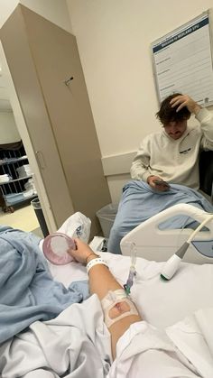 a person in a hospital bed with an iv