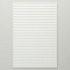 a piece of white paper with vertical lines on the top and bottom, against a gray background