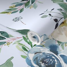 a pink wallpaper with blue flowers and green leaves on the bottom half of it