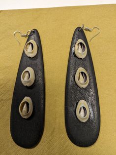 Drop down earrings. Shell accents. Available in black and brown. 5.5 inches long. Allow 2-5 business days for delivery Unique Black Pierced Earrings, Unique Black Teardrop Earrings, Accent Earrings, Long Statement Earrings, Earrings Wood, African Earrings, Wedding Jewelry Earrings, Wooden Earrings, Shell Earrings