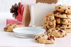 a stack of cookies sitting on top of a table next to a white plate and bowl