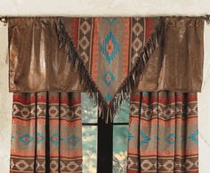 the window is decorated with native american style curtains and fringes on it's valance