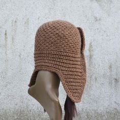 a crocheted hat on top of a mannequin head