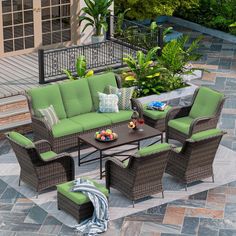 an outdoor patio furniture set with green cushions