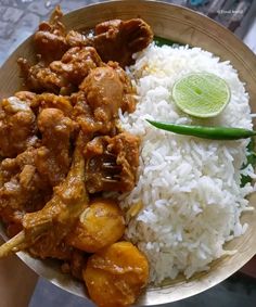 a bowl filled with rice and meat on top of a table