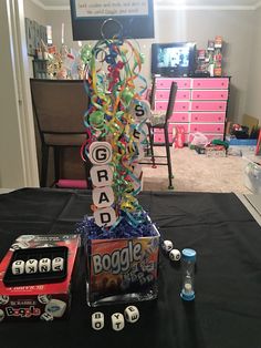 a table topped with toys and games on top of a black cloth covered tablecloth