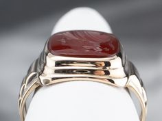 Crafted of polished 14 karat yellow gold, this is a classic of the Retro era. Carnelian is the reddish-orange version of chalcedony and can either be uniformly colored or have visible bands through the stone. In this case, the stone has been carved inwards, in the classic intaglio fashion, with the profile of a Roman Soldier. Metal: 14K Yellow Gold Gem: Carnelian Intaglio Gem Measurements: 13.8 x 11.6 mm, Cushion Cut Ring Size: 7.50 Mens Vintage Jewelry, Yellow Gold Sapphire Ring, Roman Soldier, Retro Era, Cushion Cut Ring, Reddish Orange, Cameo Ring, Yellow Gold Ring, Cushion Cut