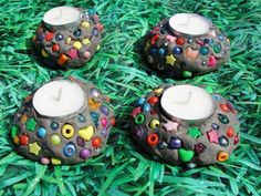 three candles are sitting in the grass