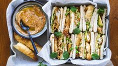 a tray filled with sandwiches and dipping sauce