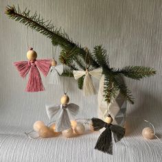 three ornaments hanging from a tree branch