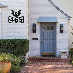 a blue front door on a white brick house