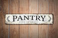 a sign that reads pantry open 24 hours hanging on a wooden wall with planks