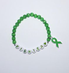 6 mm green cat's eye mental health awareness beaded word bracelet with charm. Stretch cord. Mental Health Bracelets Diy, Word Bracelet Ideas, Health Bracelet, Word Bracelet, Awareness Bracelet, Bracelet Ideas, Health Awareness, Mental Health Awareness, Austin Tx