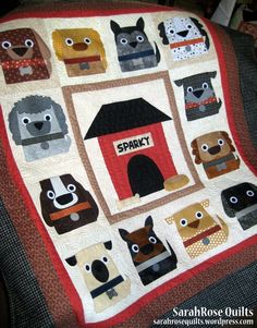 a quilted doghouse with many dogs on it and the words sparky written in white