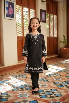 2-Piece Embroidered Suit for Girls (shirt & trouser only) : A classic state-of-the-art monochromatic design envisioning captivating details that make this two-piece staple a perfect style statement your daughter. Description -- Kameez (Shirt) : Paper Cotton shirt. Lining included. -- Shalwar (Trouser) : Black Pants. General Care Instruction : Should be hand washed and hung to dry. Color may bleed so please be mindful of other items with it. General Disclaimer -- Size chart provides reference siz Fitted Sets With Embroidered Sleeves For Eid, Cotton Set With Embroidered Sleeves For Eid, Festive Cotton Sets With Embroidered Sleeves, Festive Unstitched Sets With Embroidered Sleeves, Unstitched Sets With Embroidered Sleeves For Festive Occasions, Fitted Cotton Sets With Embroidered Sleeves, Black Sets With Embroidered Sleeves For Eid, Black Festive Set With Embroidered Sleeves, Festive Black Set With Embroidered Sleeves