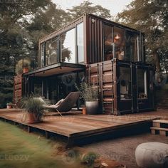 a house made out of shipping containers sitting on top of a wooden deck